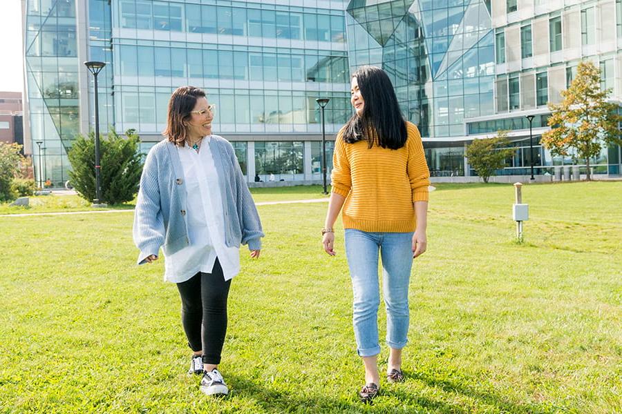 Students walking in front of the Integrative Sciences Complex at UMass Boston.